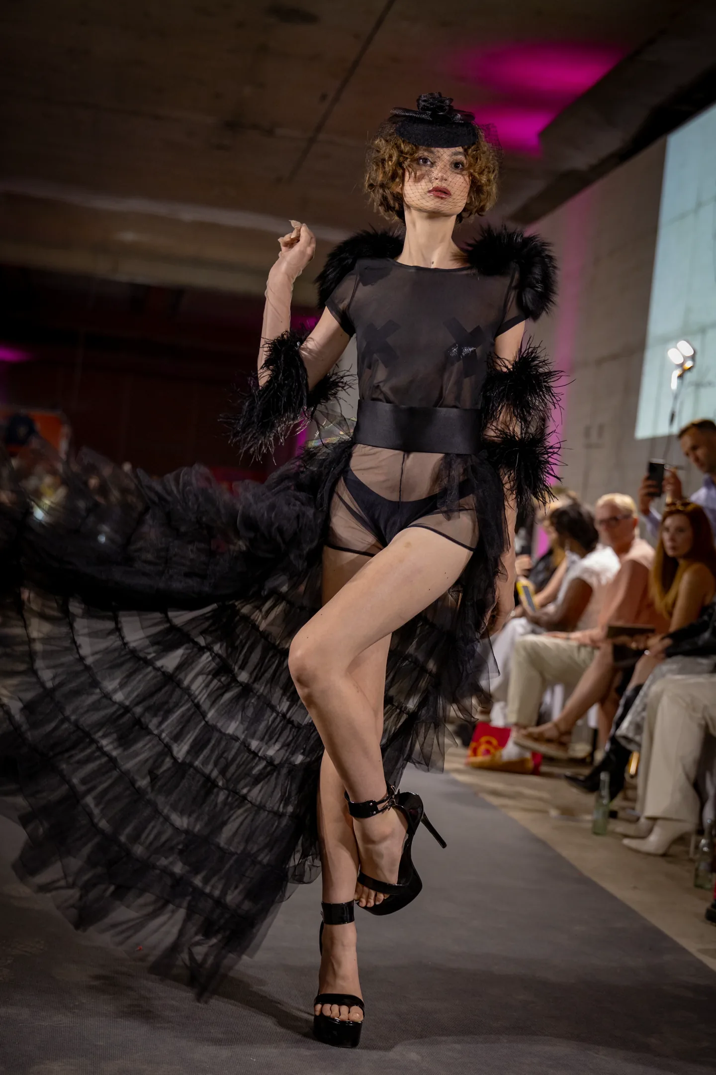 Editorial close-up in black mesh and theatrical styling.