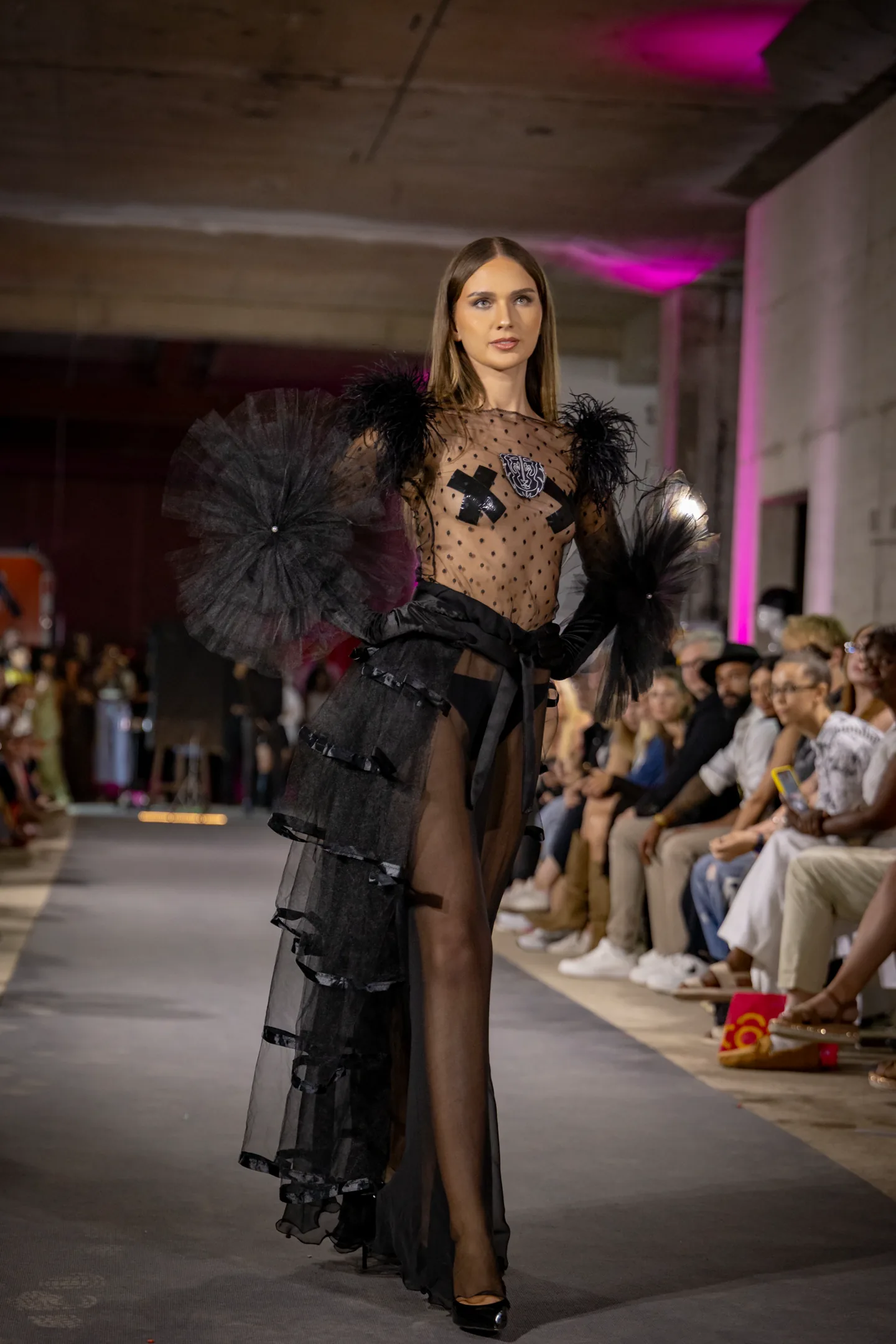 Fashion portrait under magenta architectural lighting.